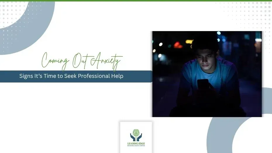 Young person sitting alone at night looking at phone, representing coming out anxiety and LGBTQ+ mental health support